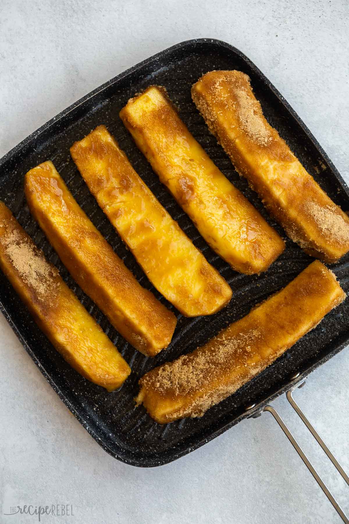 pineapple spears on grill pan ready to grill.