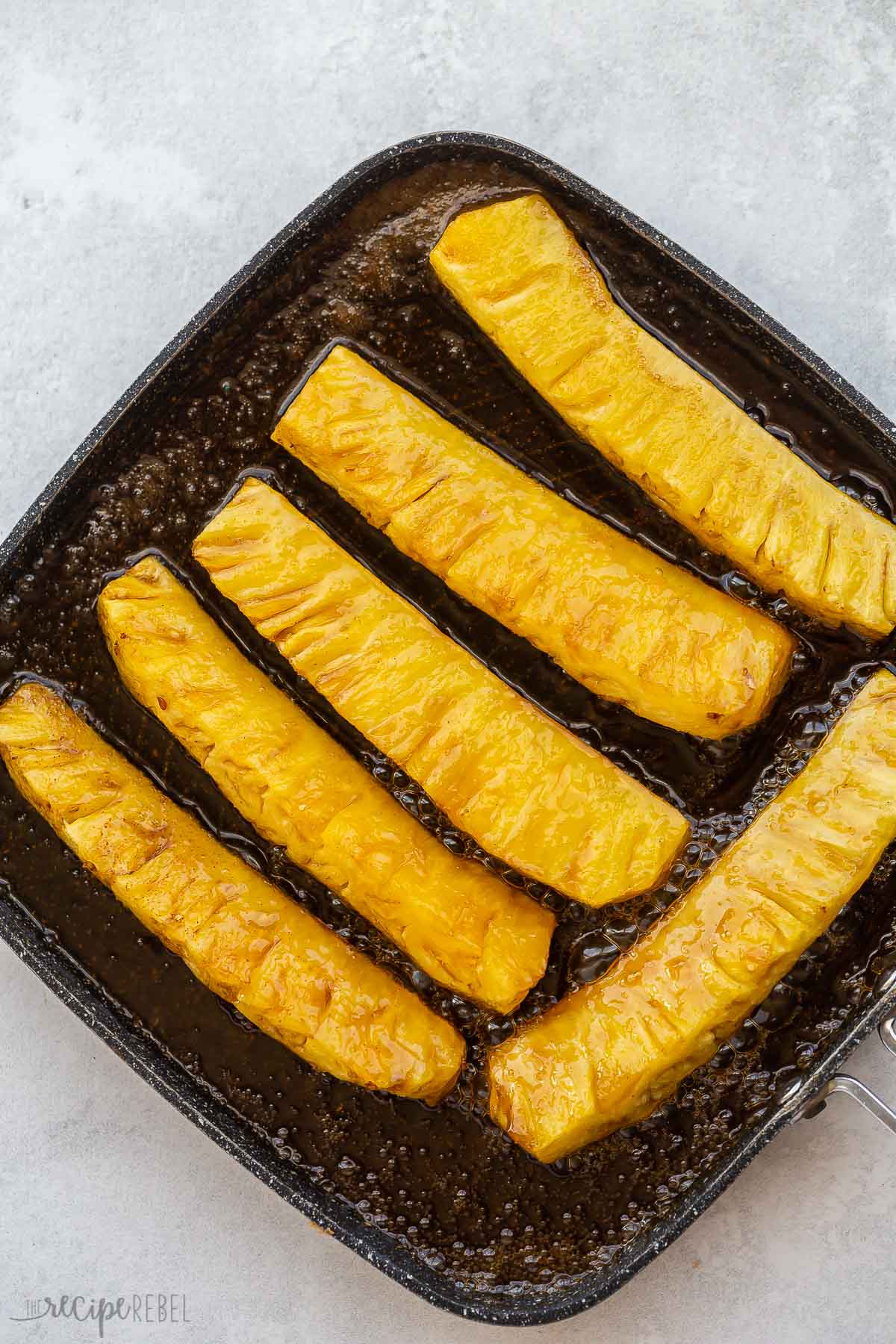 pineapple spears on grill pan after grilling.