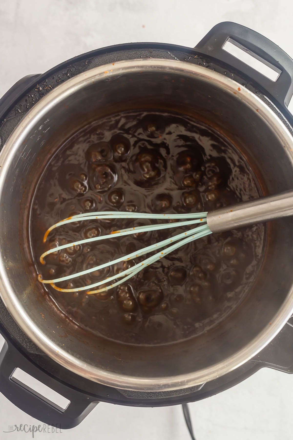 whisking sauce to thicken after pulled pork is cooked.