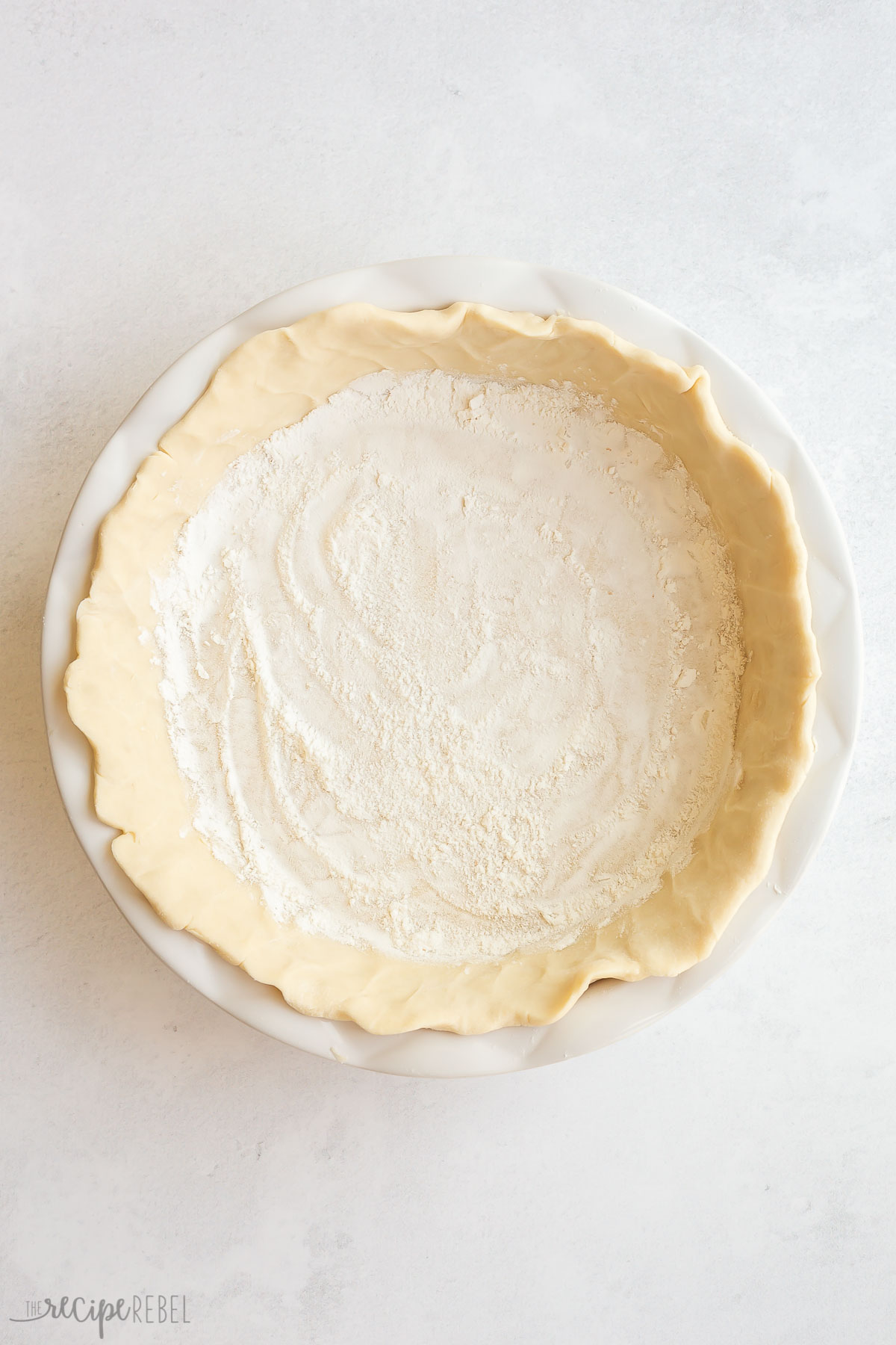 unbaked pie crust with flour sprinkled in the bottom.