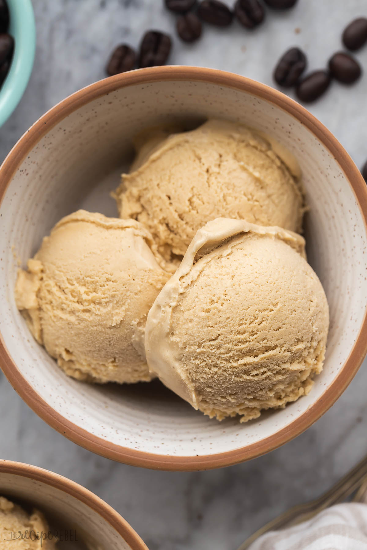 close up image of three scoops of coffee ice cream in a bowl.