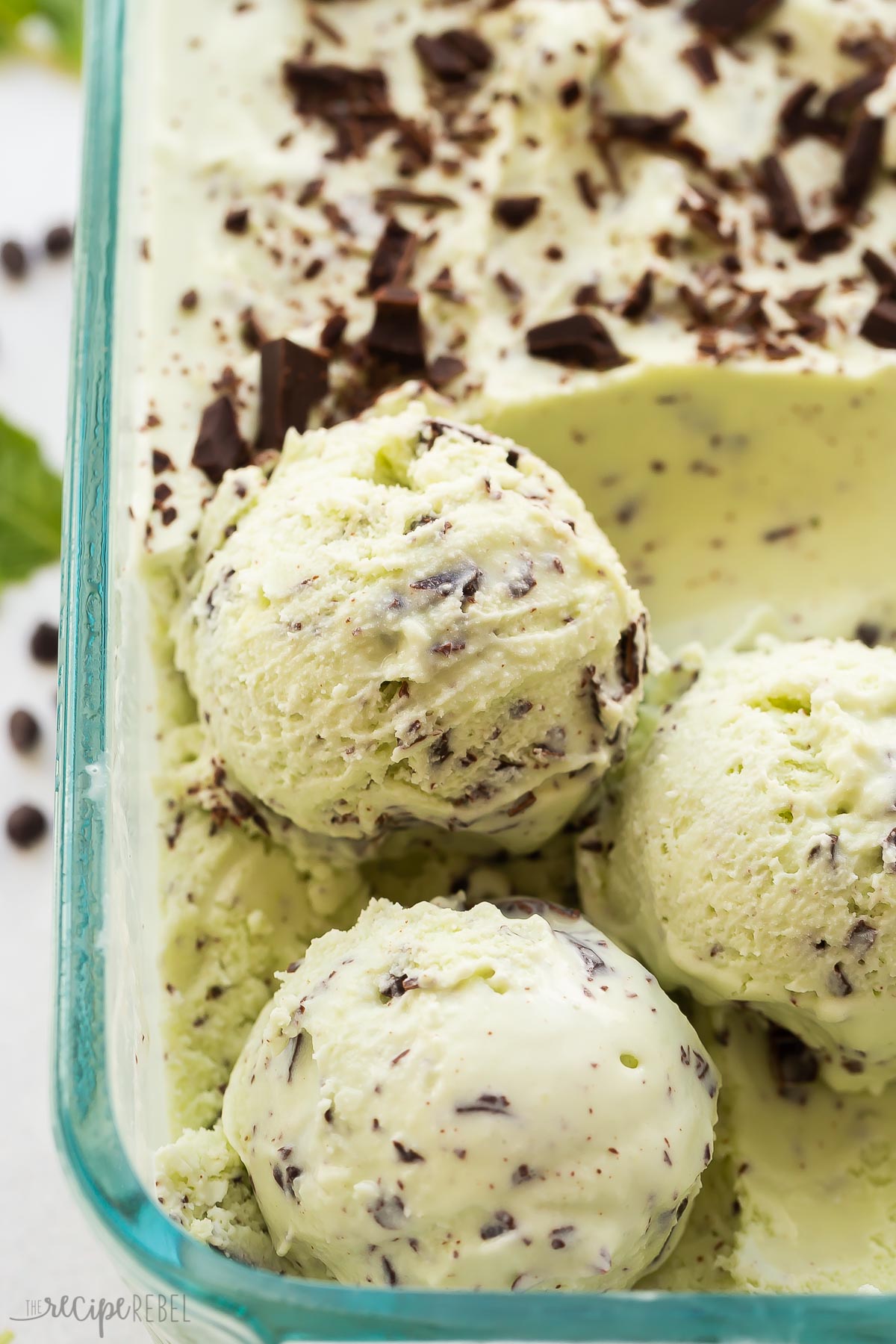 close up image of three scoops of mint chocolate chip ice cream.
