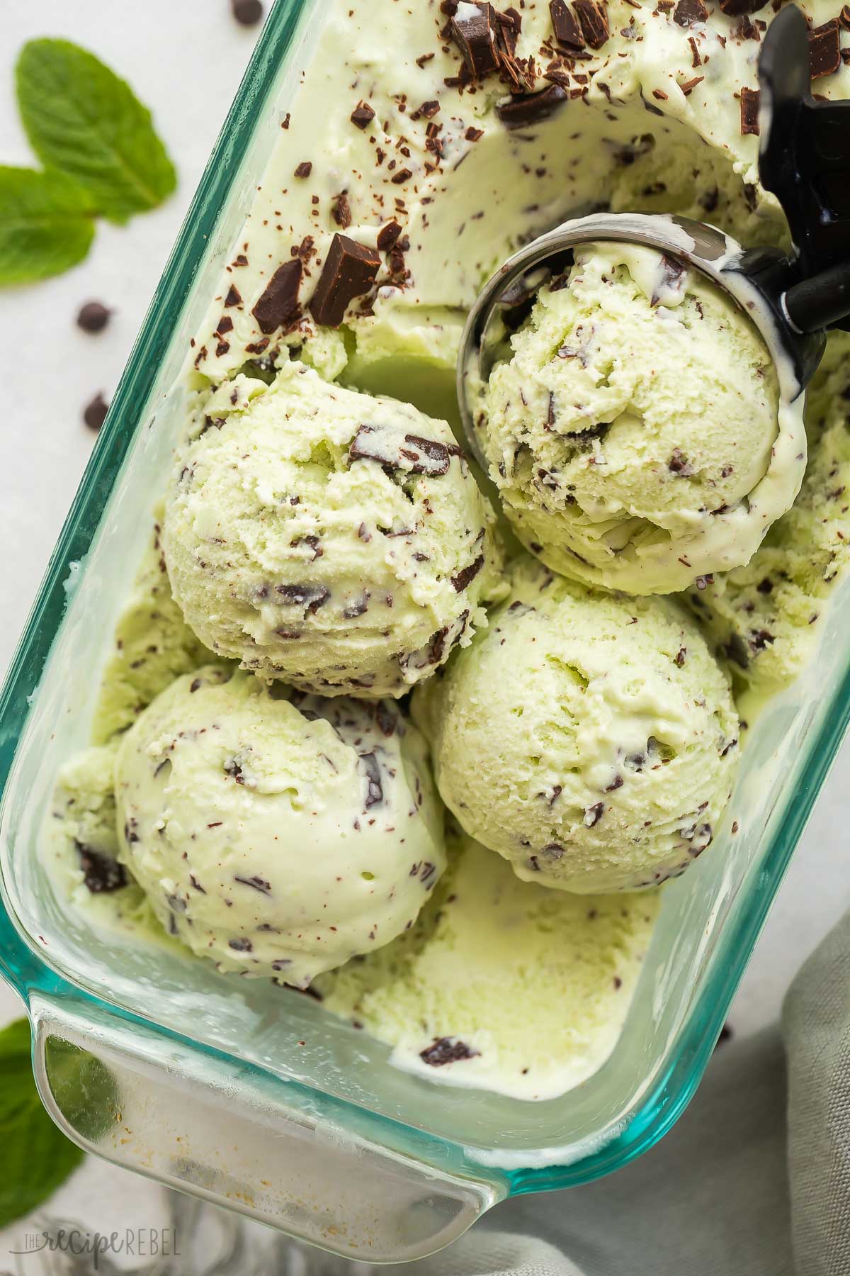 overhead image of four scoops of mint chip ice cream in glass loaf pan.