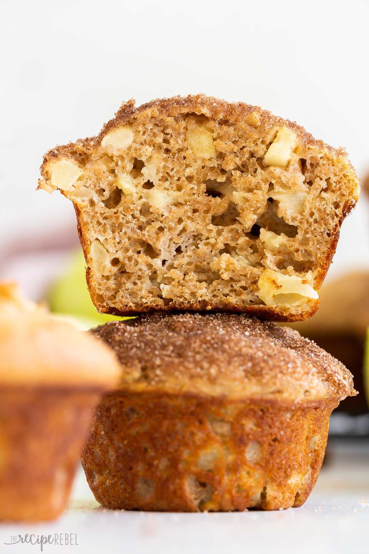 half of apple cinnamon muffin stacked on top of whole muffin.