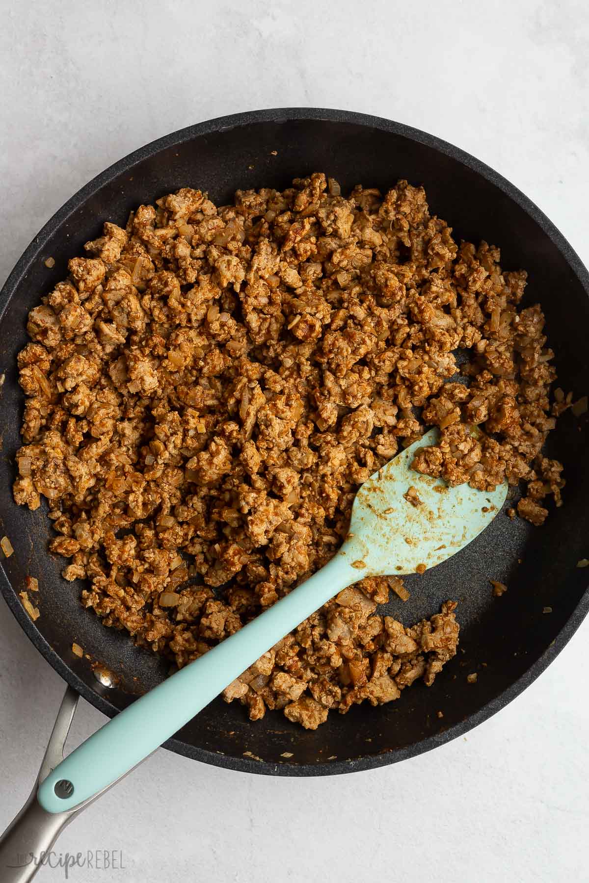 seasoned turkey taco meat in black skillet.