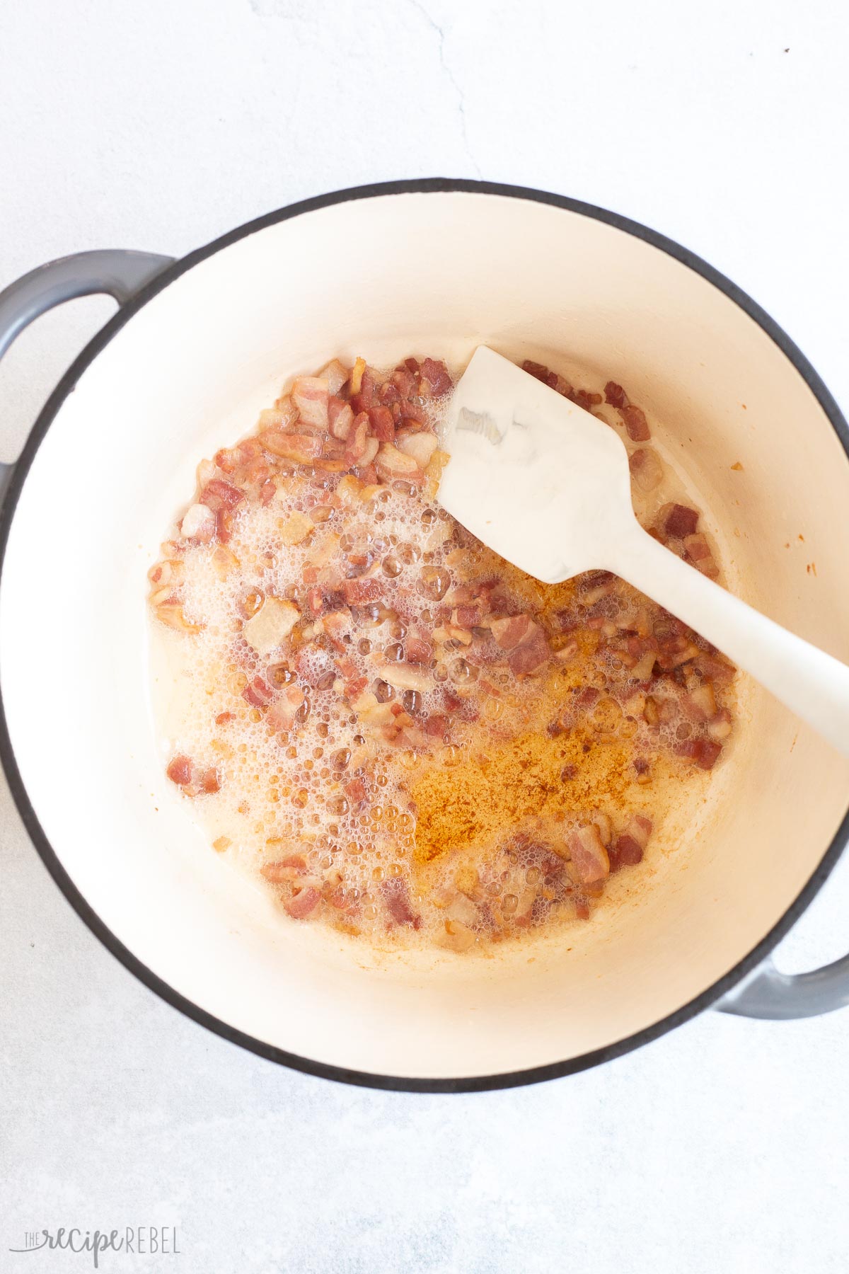 bacon cooking in bottom of pot.