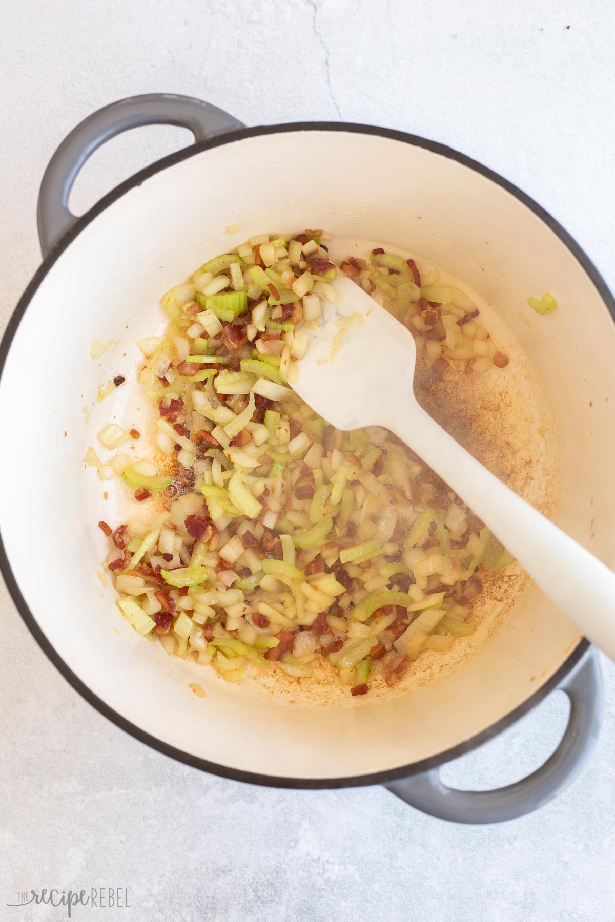 onions added to bacon in pot.