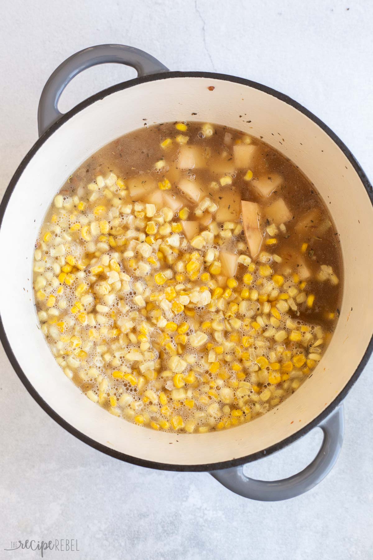 potatoes and corn added to soup.