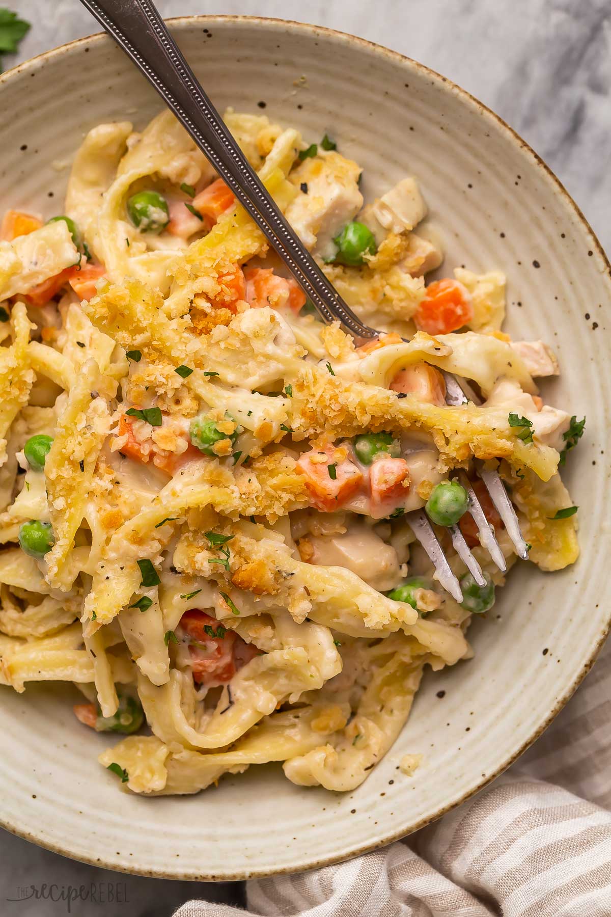close up image of chicken noodle casserole with fork.