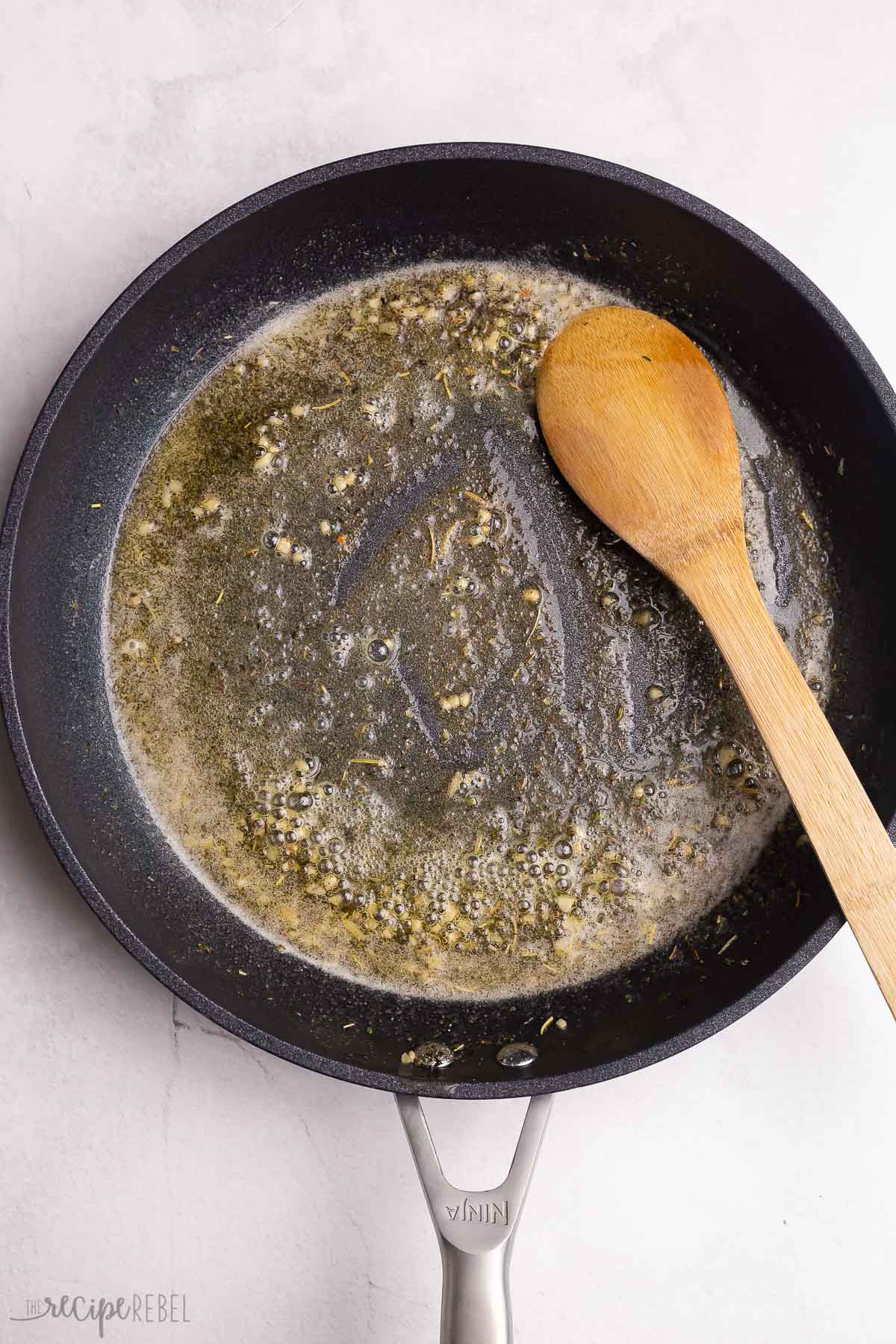 butter and garlic in black skillet.