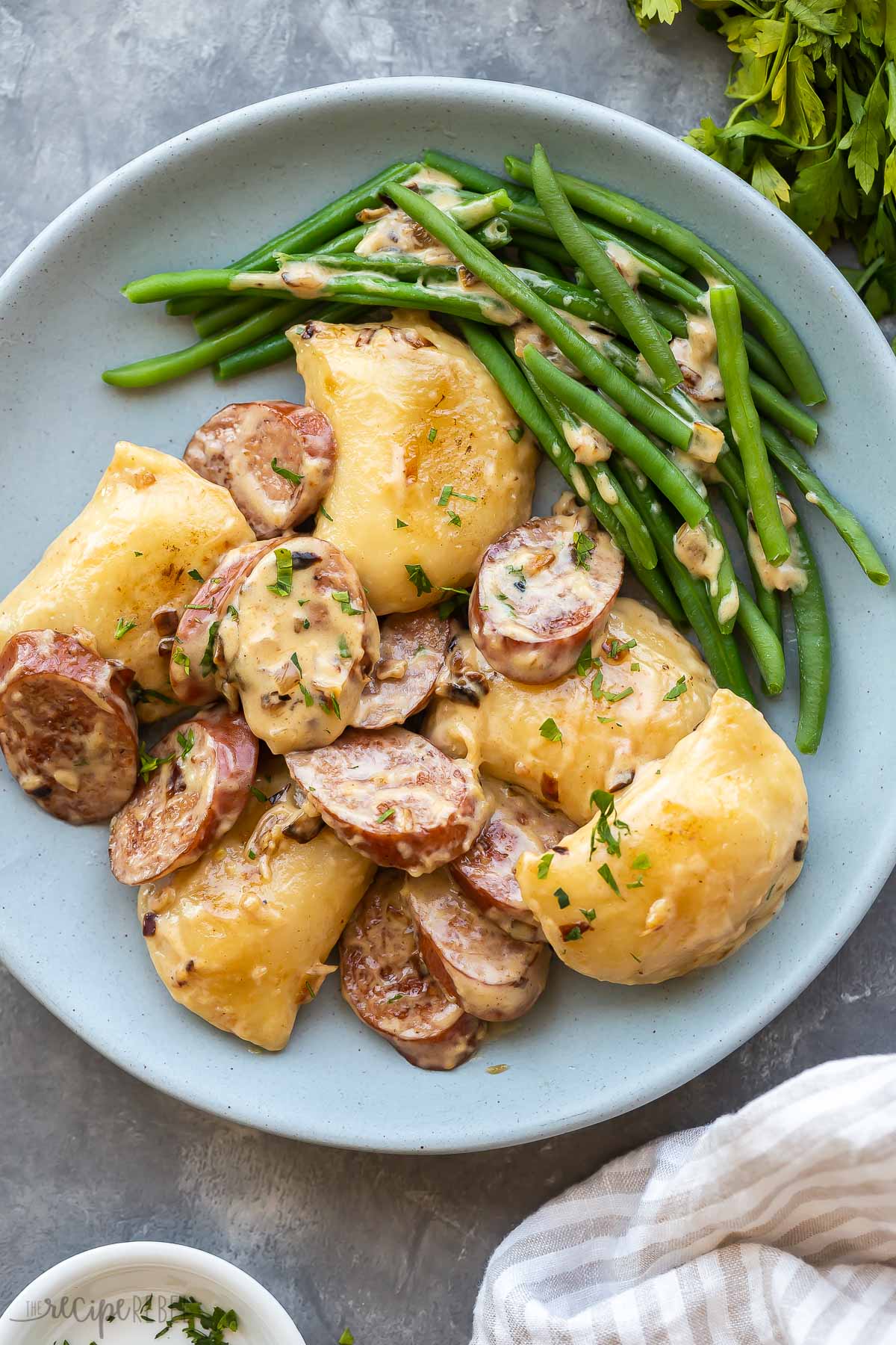 perogies and sausage on a plate with green beans.