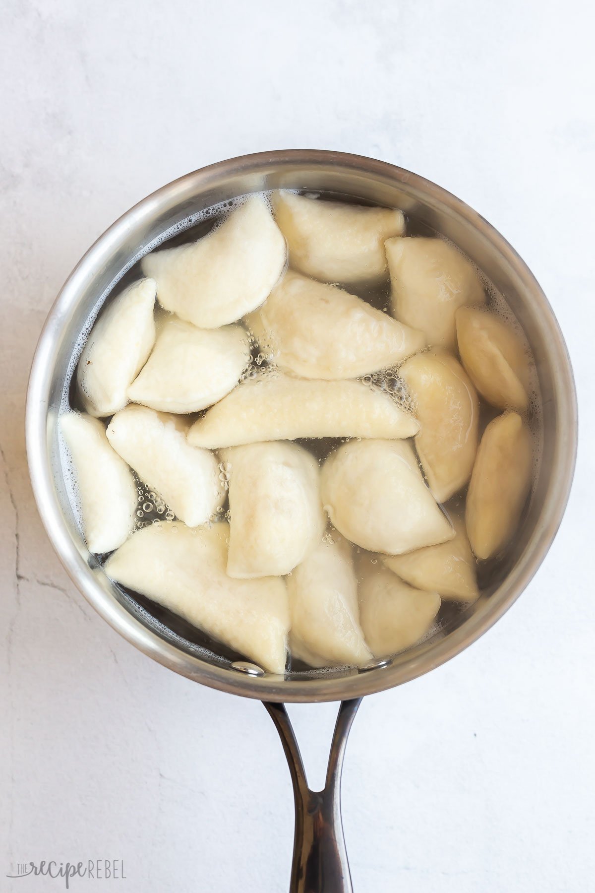 perogies boiling in pot of water.