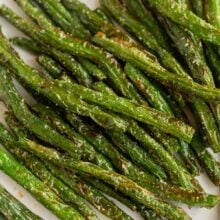 close up image of air fryer green beans on plate.