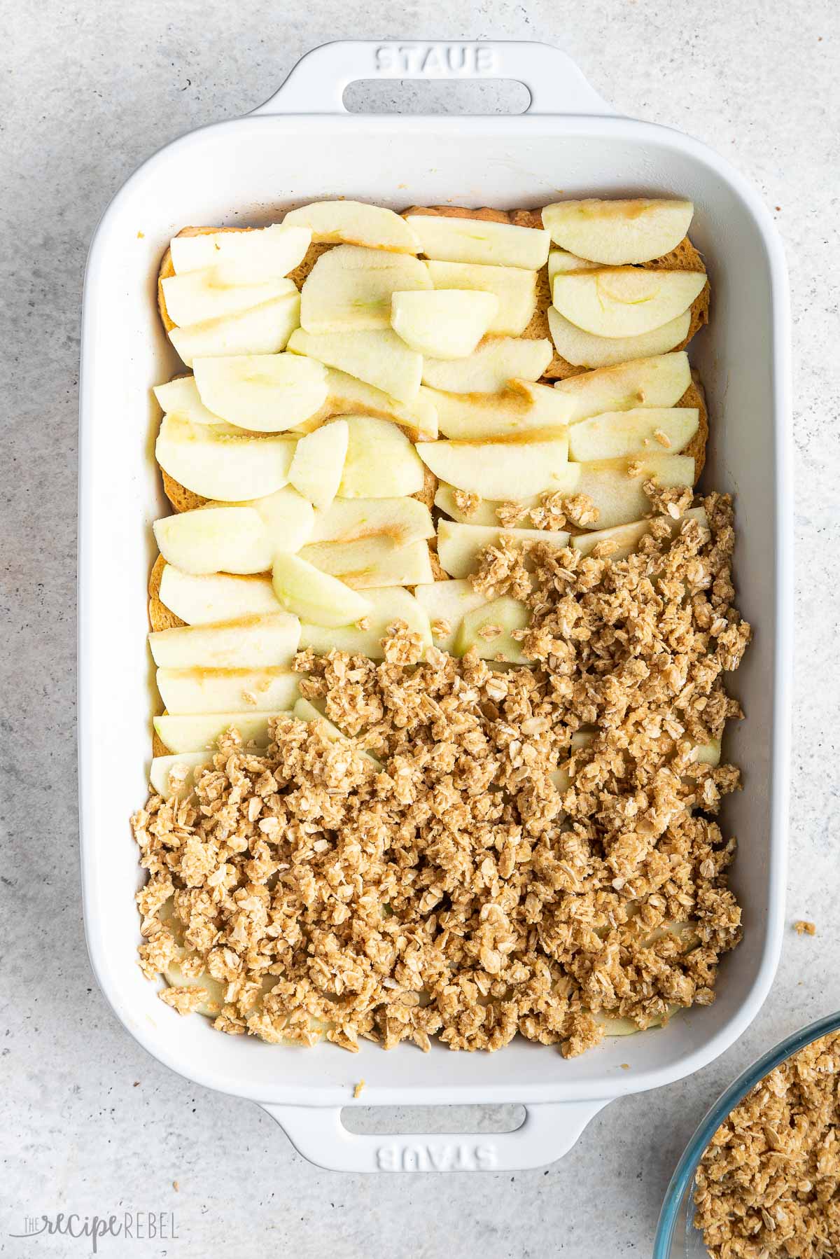 streusel added on top of apples in baking dish.