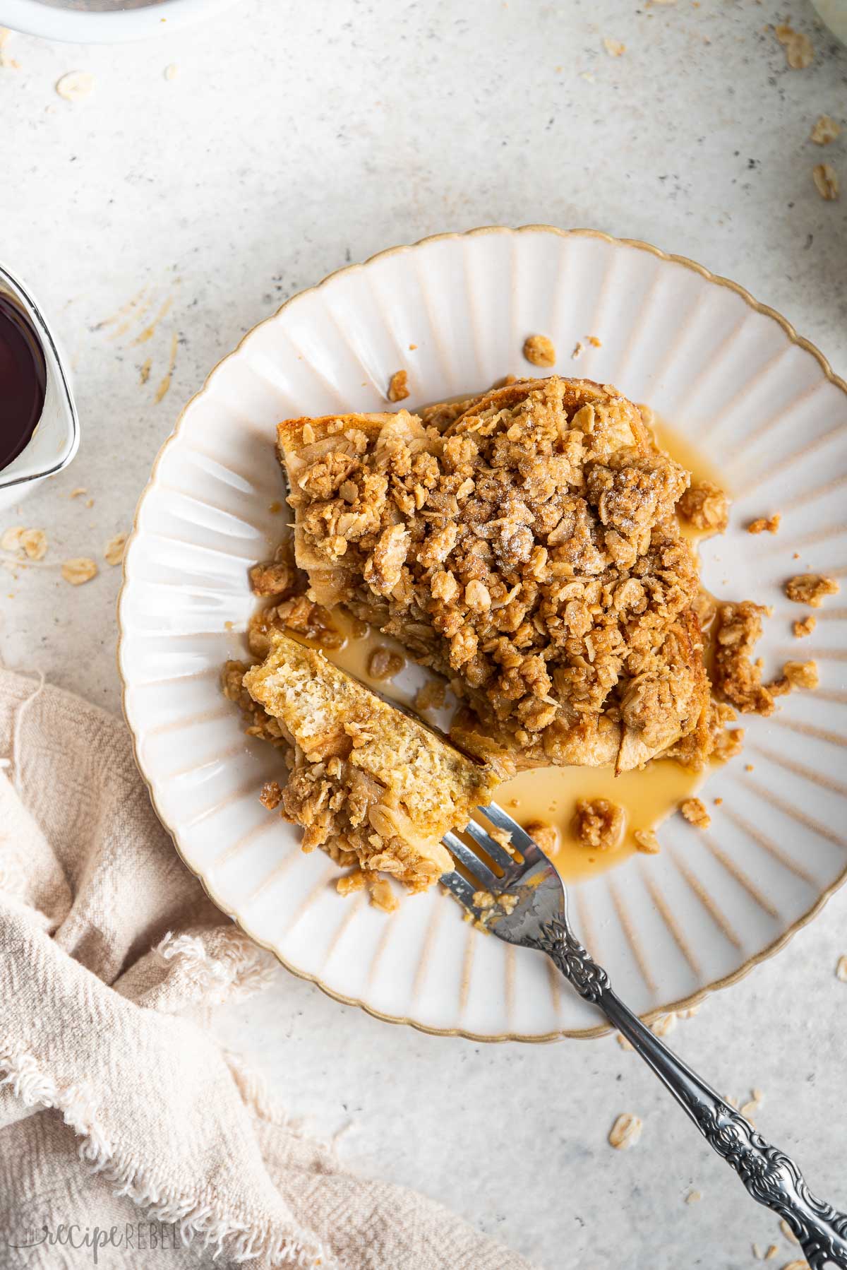 overhead image of apple crisp french toast on white plate with fork.