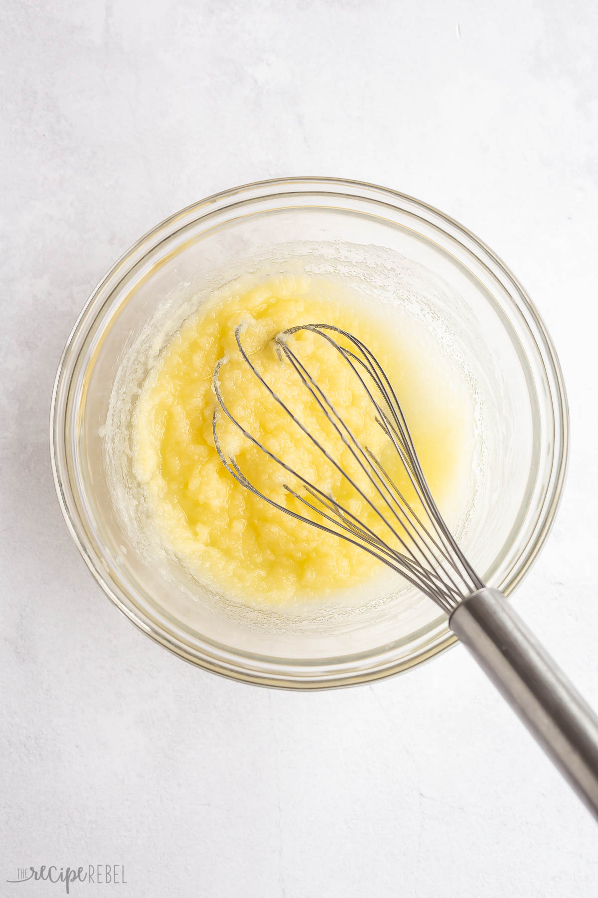 butter and sugar mixed together in glass bowl.