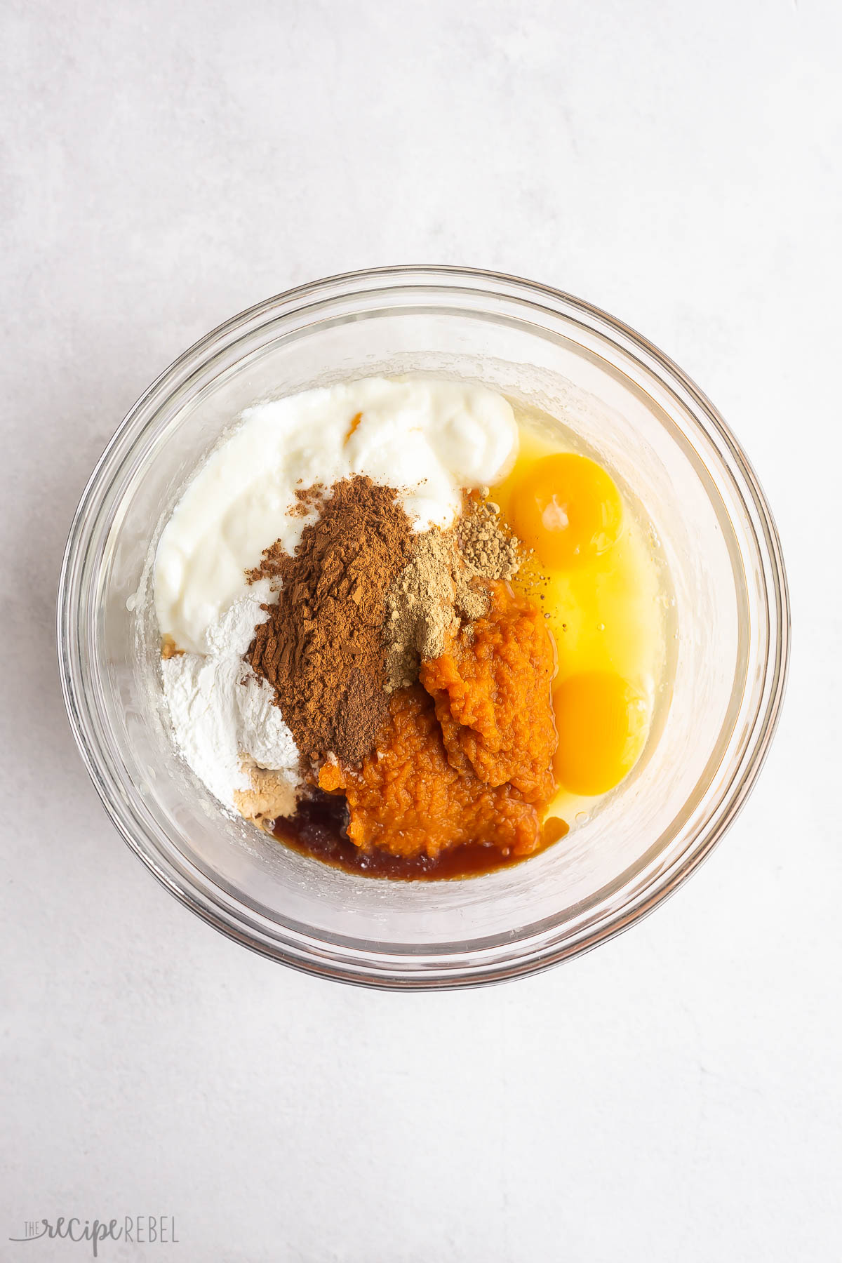 all wet ingredients for pumpkin bread in glass bowl.