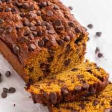 close up image of pumpkin chocolate chip bread with two slices cut.
