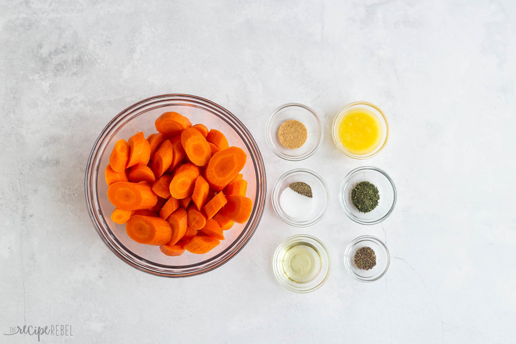 ingredients needed for roasted carrots on white background.