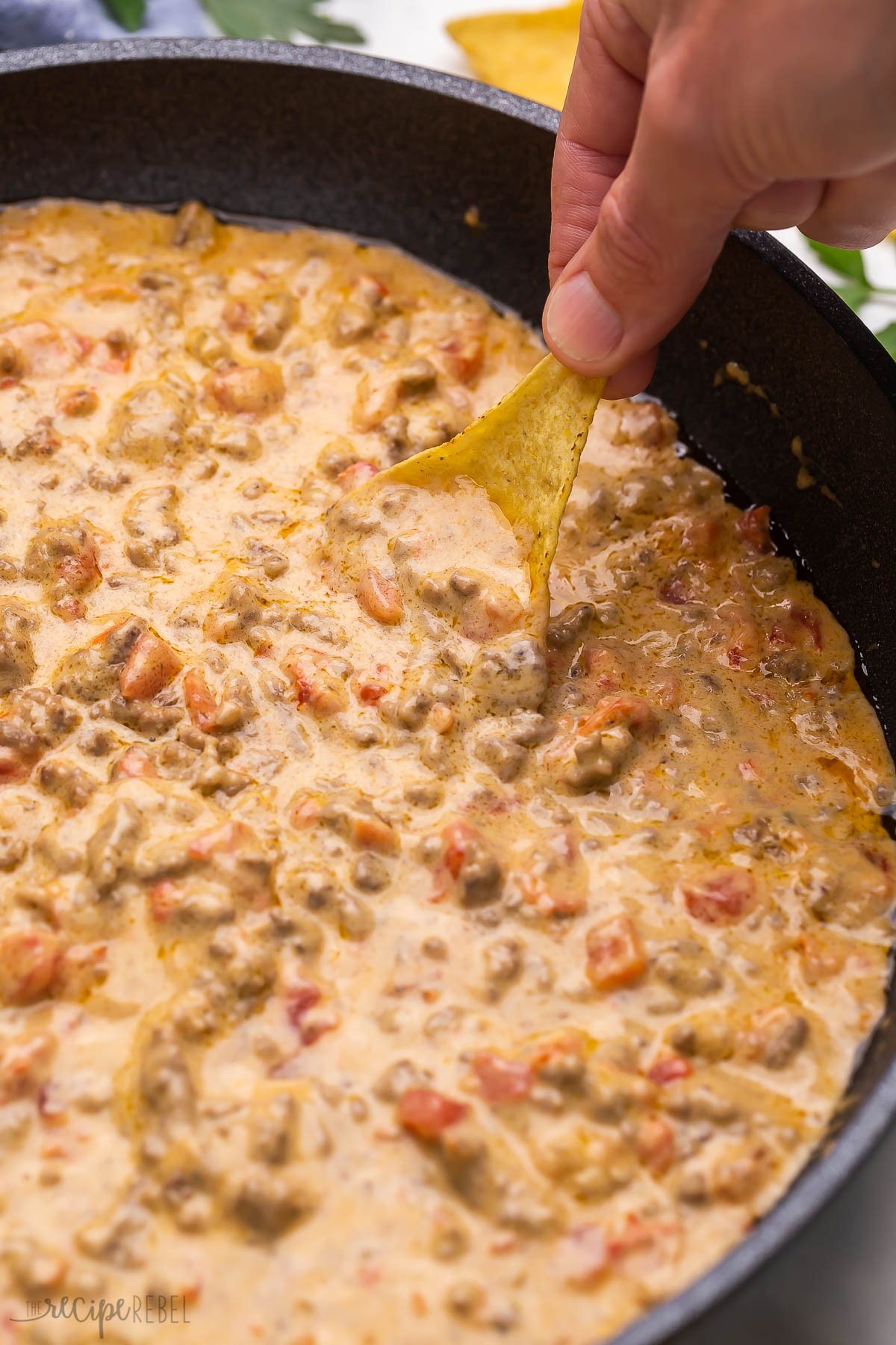 Top view close up image of chip scooping rotel dip.