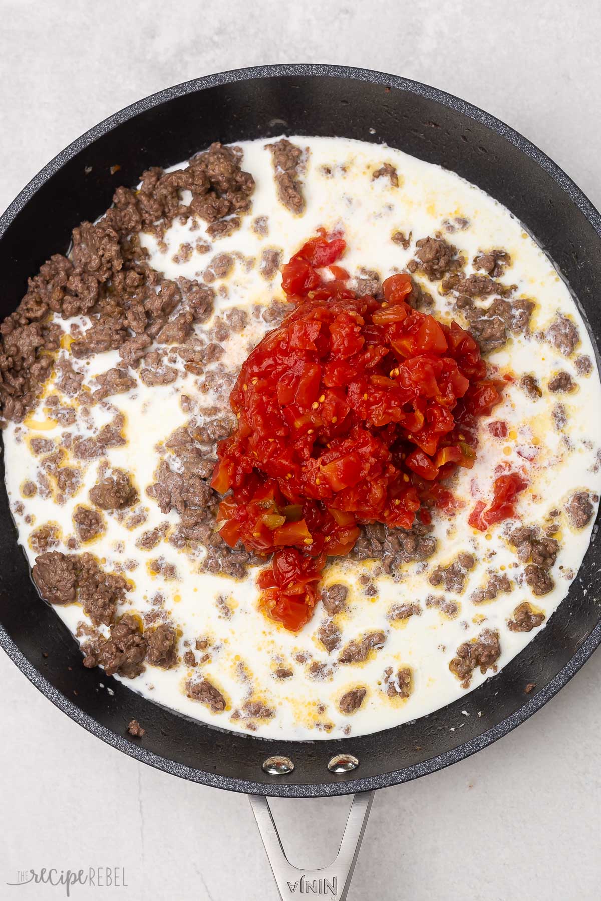 cream and rotel tomatoes added to ground beef in skillet.