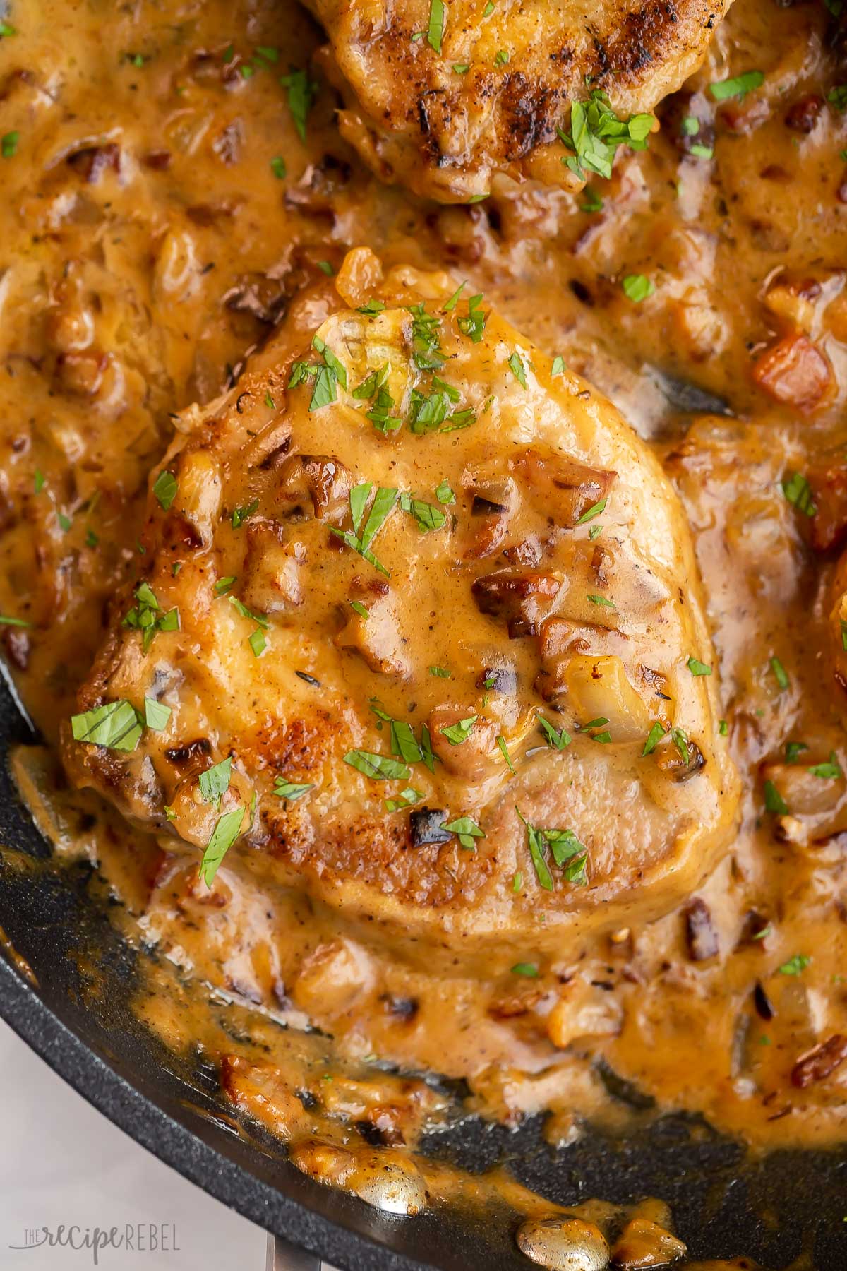 close up overhead image of boneless pork chop with gravy.