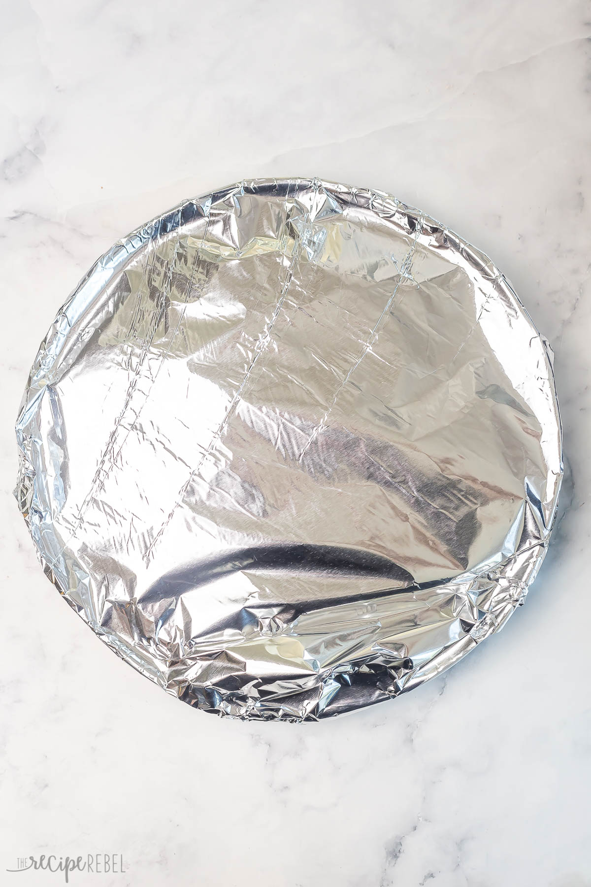 pork chops on plate with tin foil to keep warm.