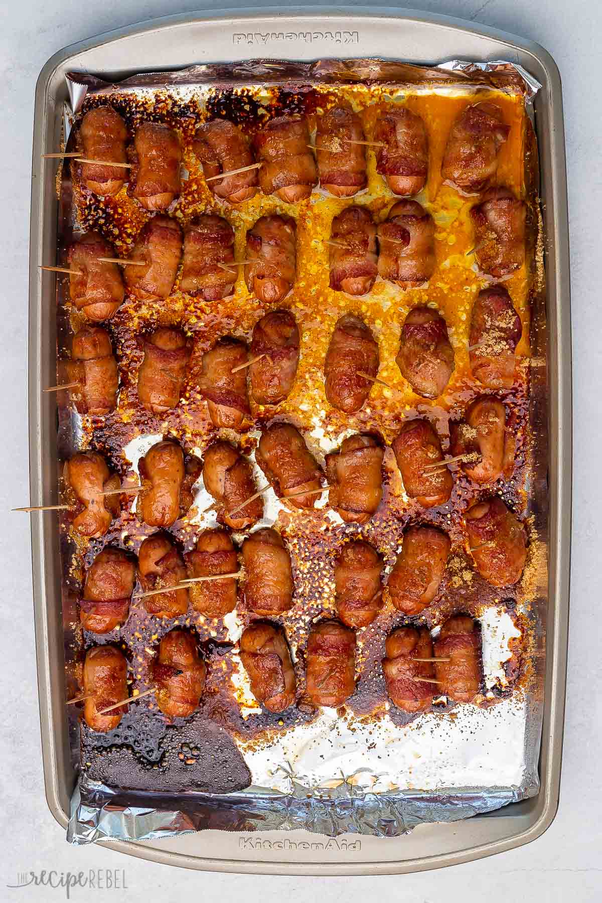 crispy bacon wrapped smokies on sheet pan with foil.
