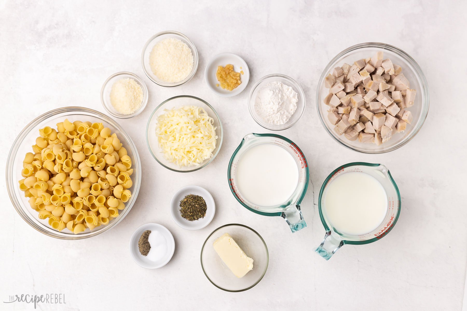 ingredients needed for chicken alfredo bake on white background.