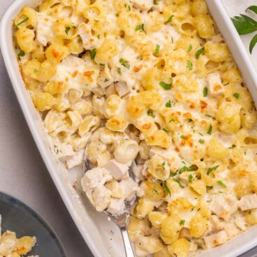 overhead image of chicken alfredo bake with spoon stuck in.