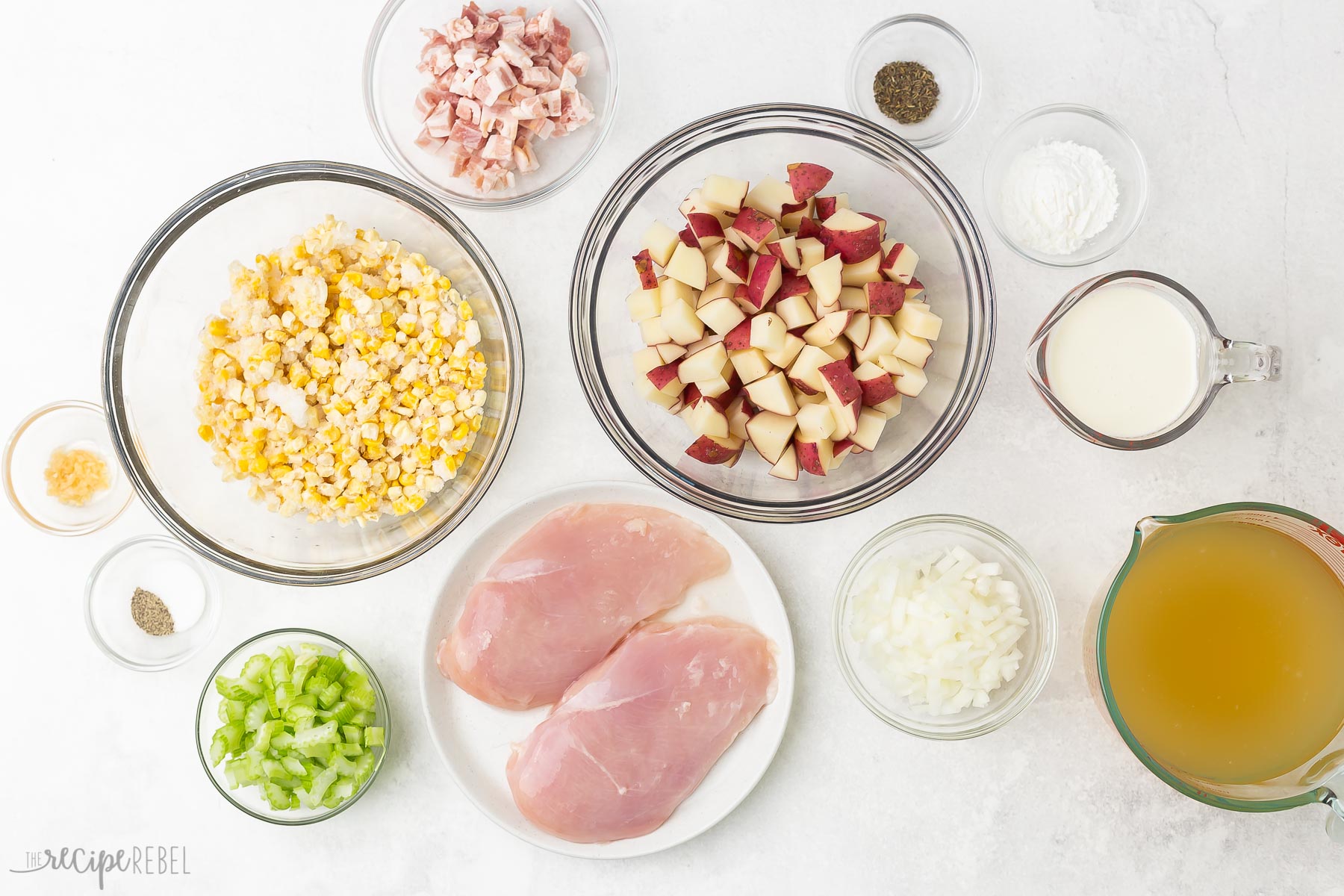 ingredients needed for chicken corn chowder on white background.