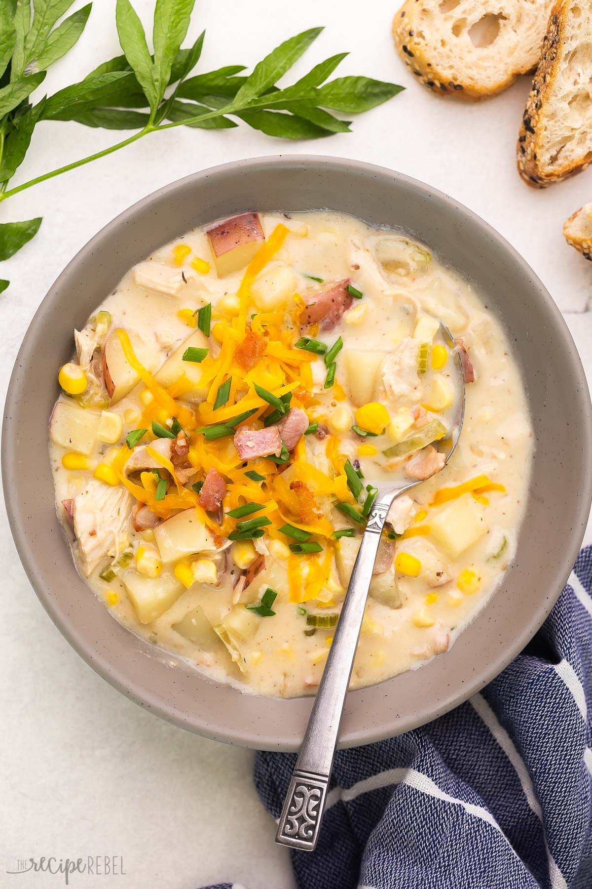 bowl of chicken corn chowder with spoon stuck in.