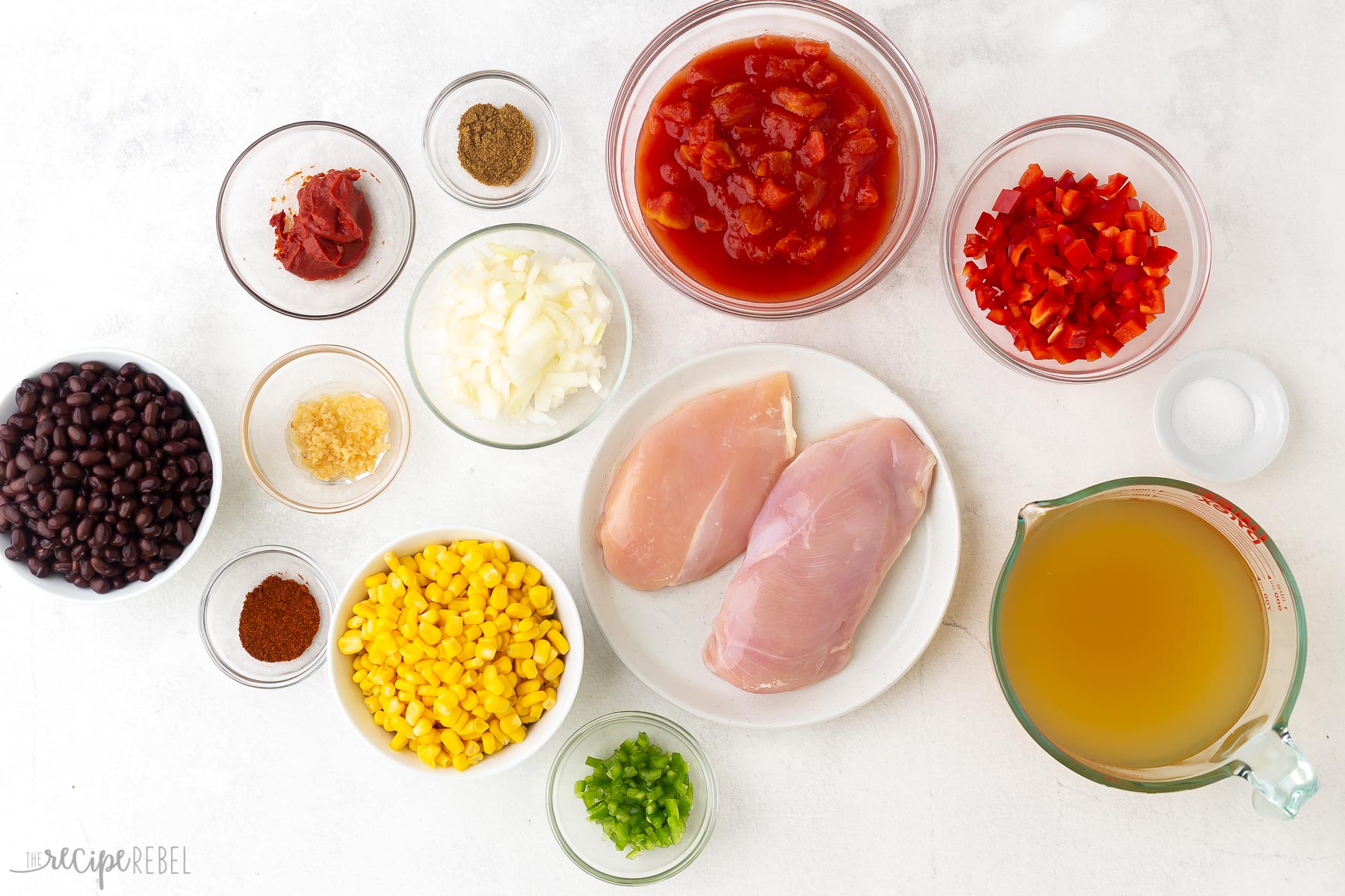 ingredients needed for chicken tortilla soup on white background.