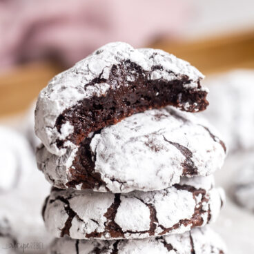 square image of chocolate crinkle cookies stacked.