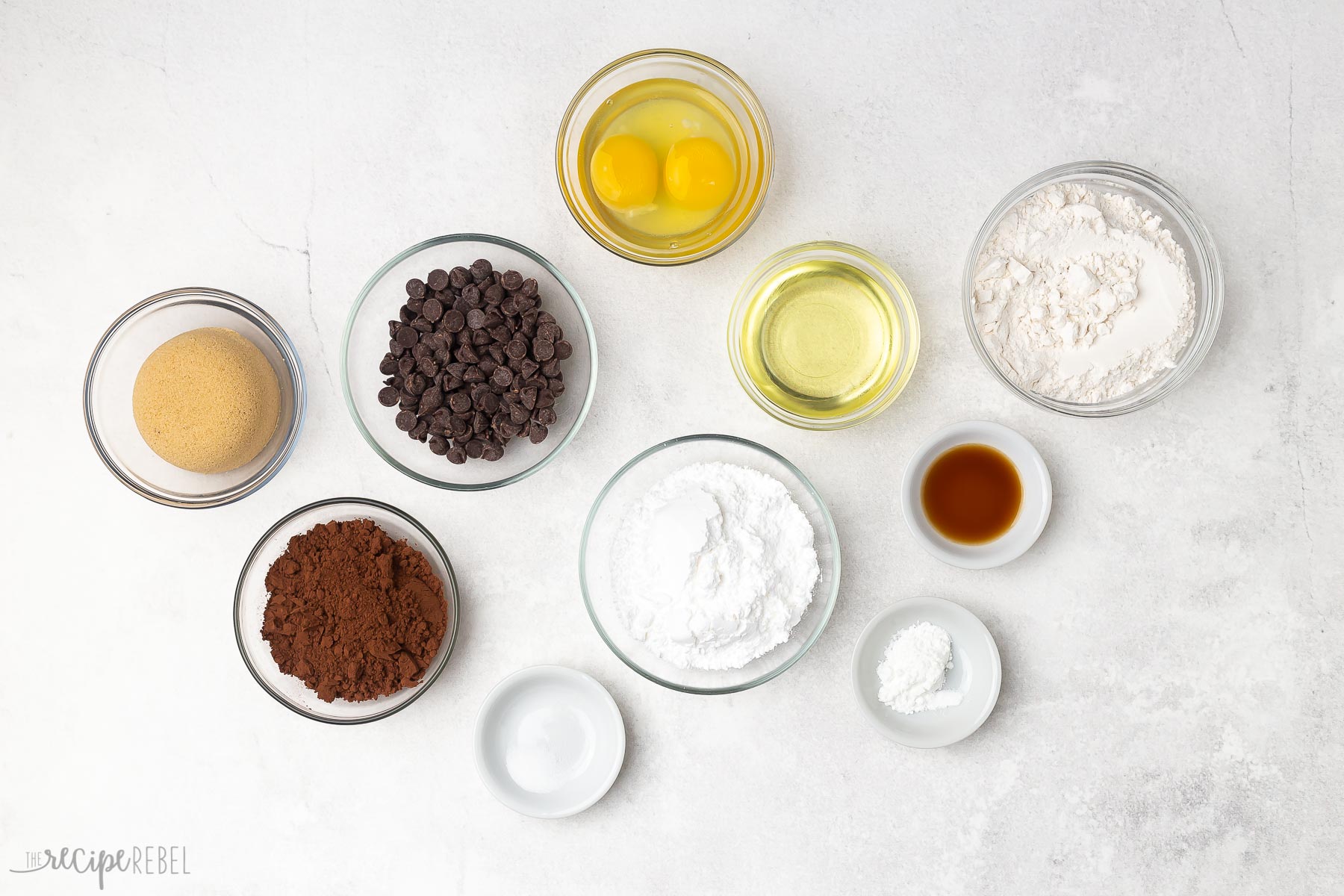 ingredients needed for chocolate crinkle cookies on white background.