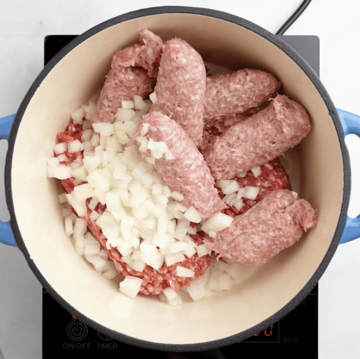 ground beef and sausage added to pot to make easy lasagna sauce.