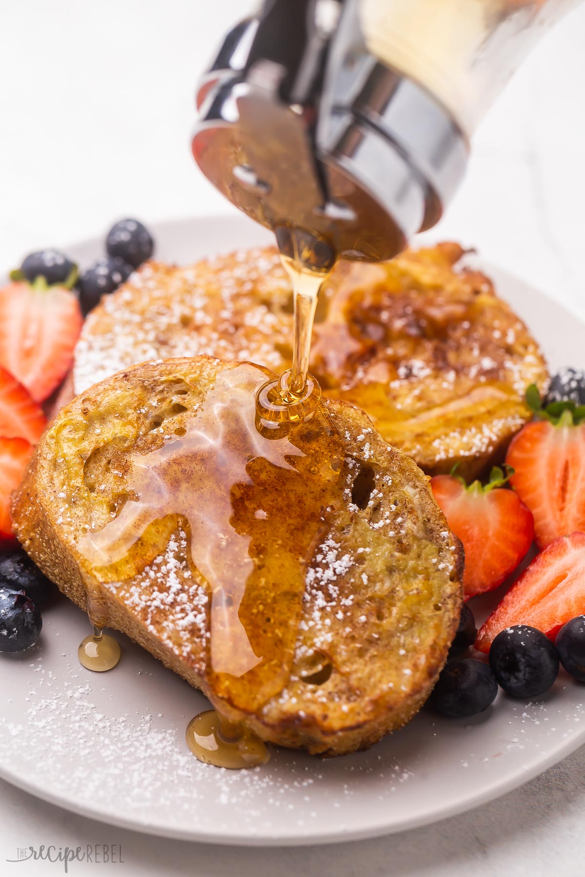 close up of syrup being poured on golden french toast.