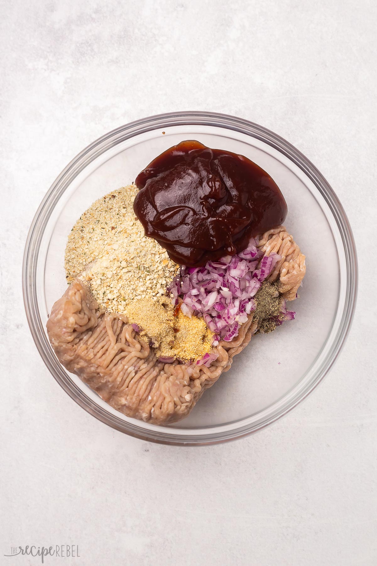 glass bowl of unmixed turkey burger ingredients.