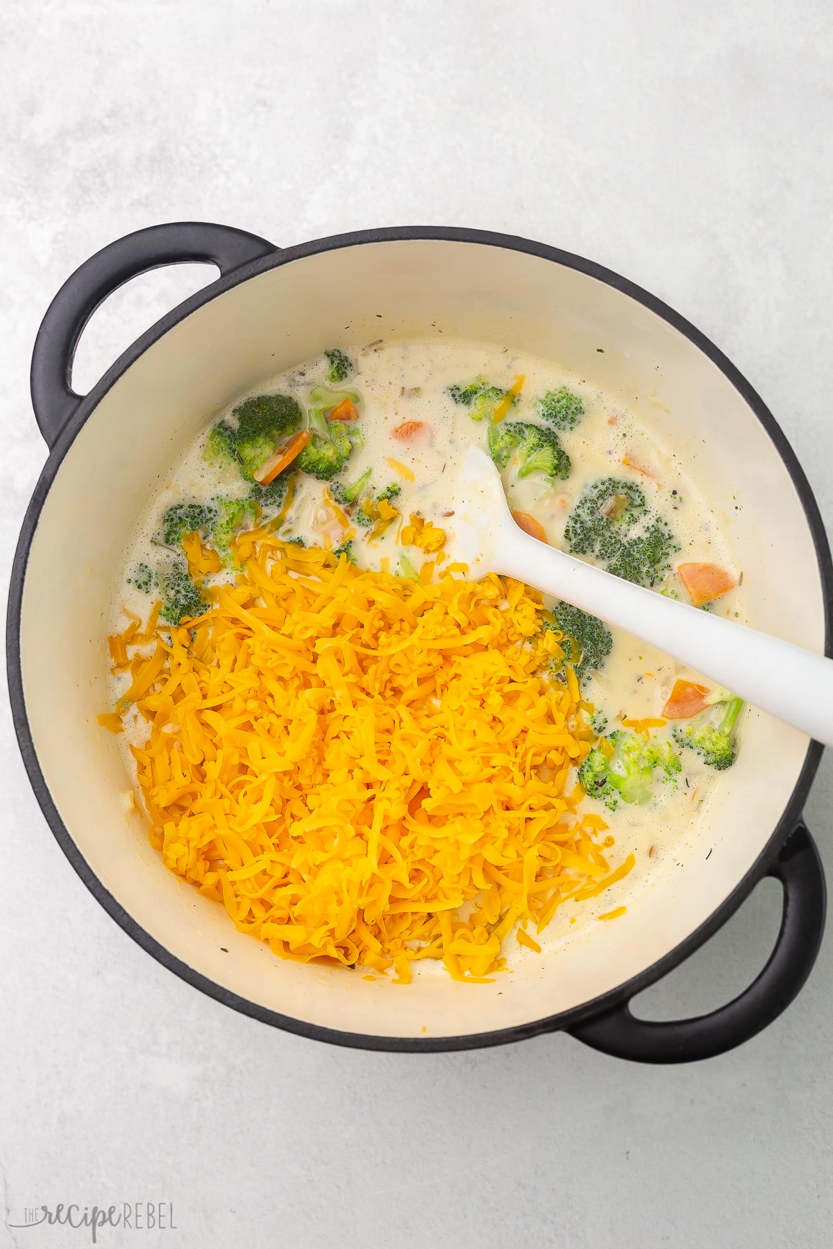 cheddar cheese on top of broccoli cheddar soup.