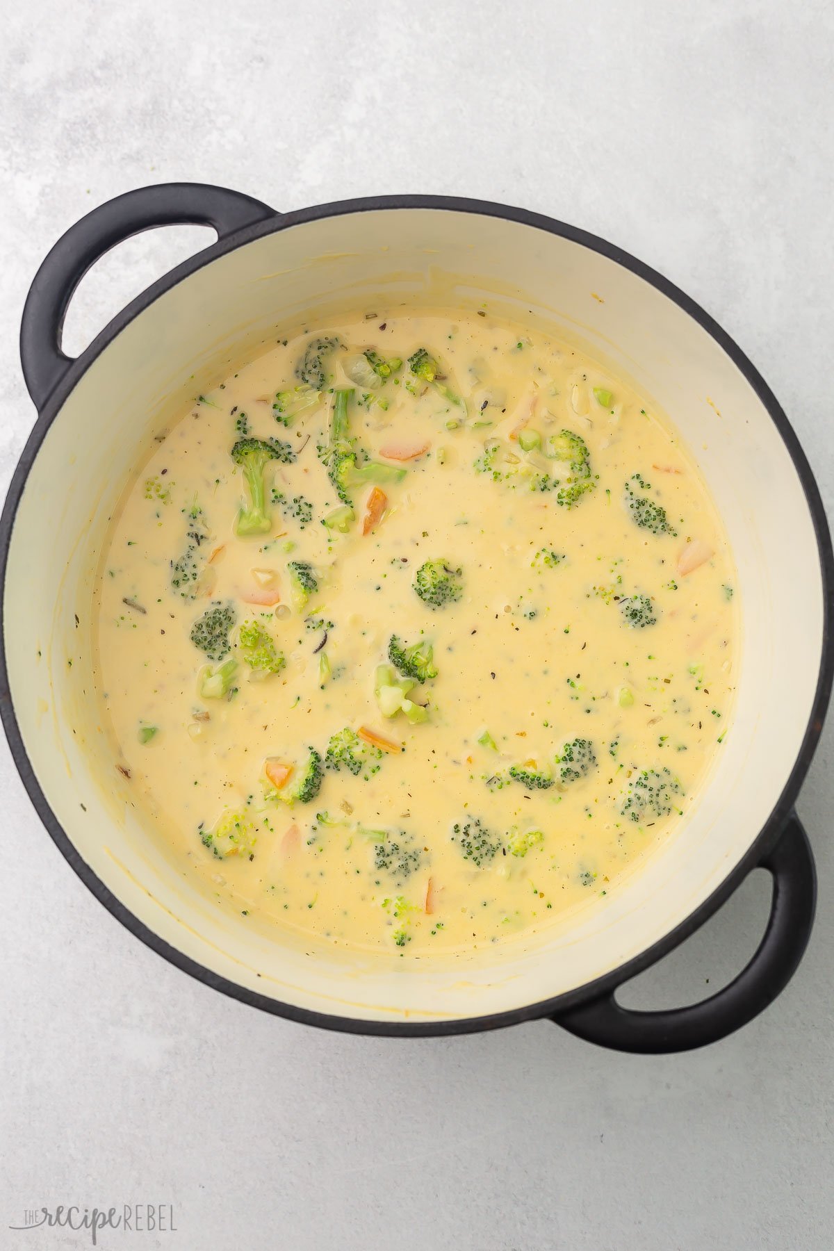 overhead of cooked broccoli cheddar soup in pot.