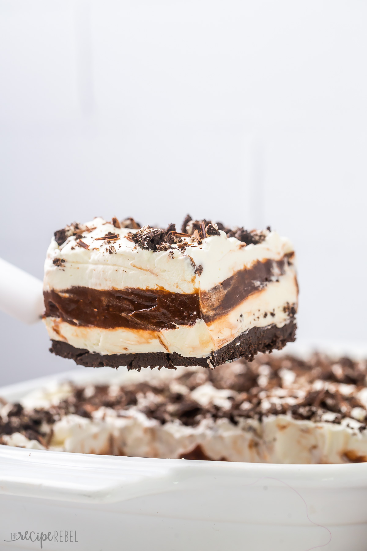 a piece of chocolate lasagna held above the pan.