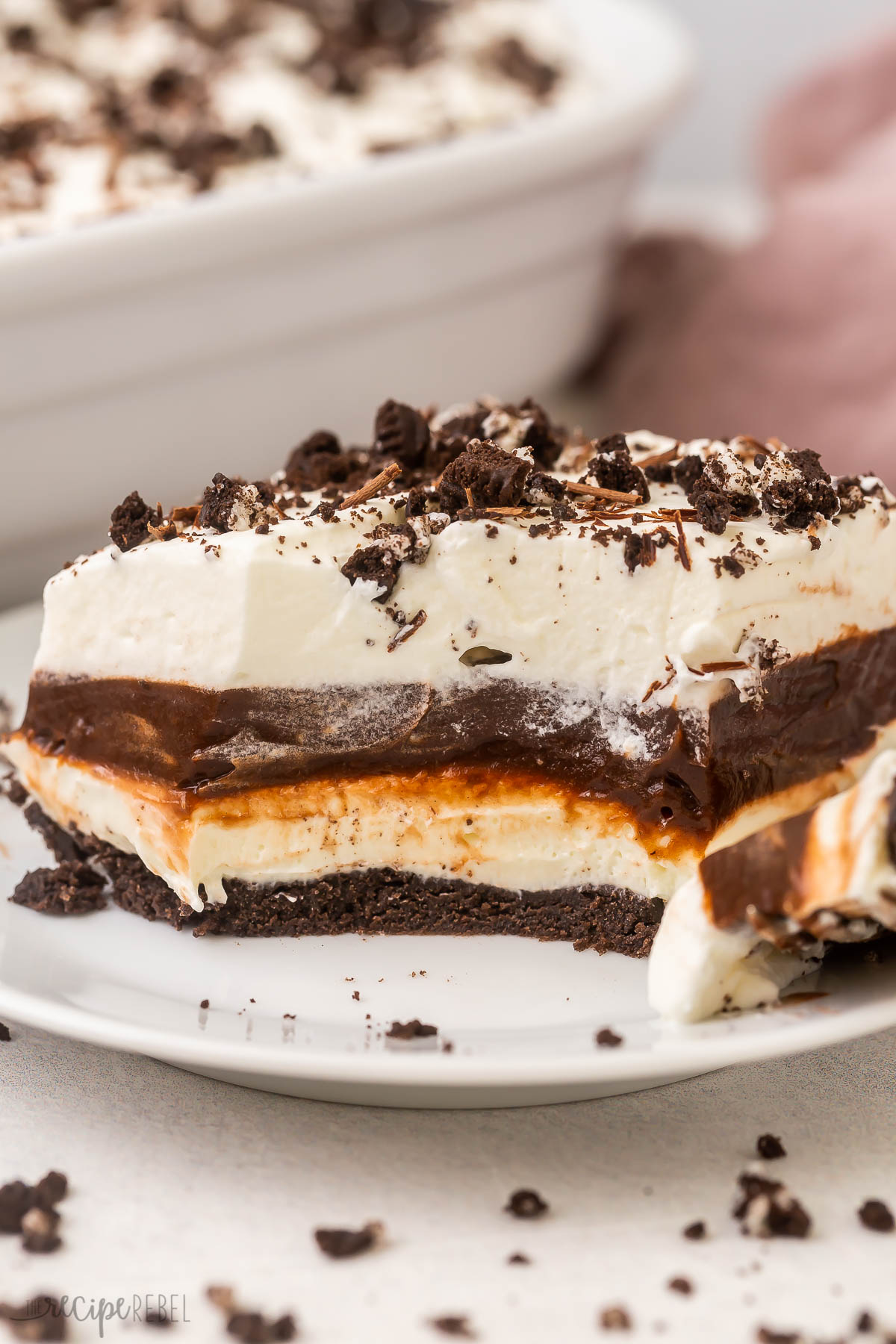 a close up shot of chocolate lasagna piece on a white plate.