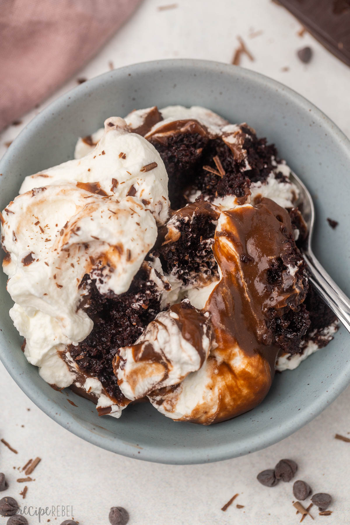 chocolate trifle in blue bowl with spoon.