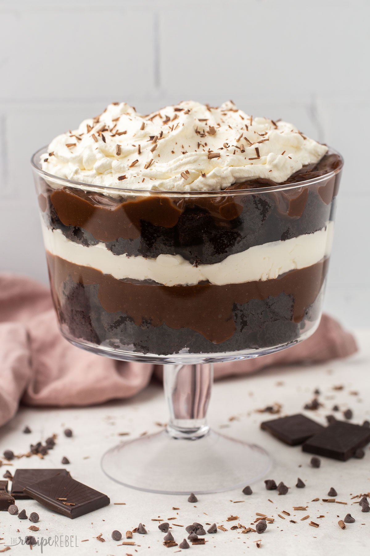 This Chocolate Trifle is an easy dessert recipe that's totally decadent! It's made with layers of homemade cake, chocolate pudding, and whipped cream. #chocolate #dessert | dessert recipe | easy recipes | easy dessert | chocolate dessert | christmas dessert full glass bowl of chocolate trifle.