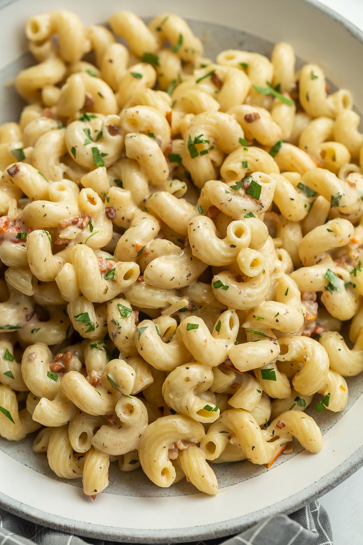 close up image of finished cavatappi pasta in grey plate.