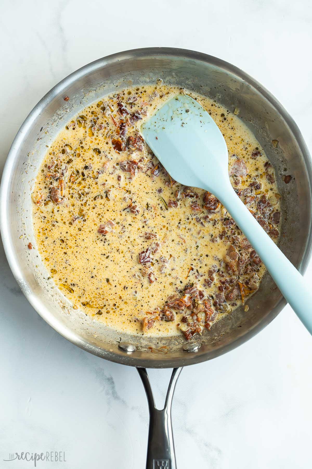 cream added to bacon in skillet.