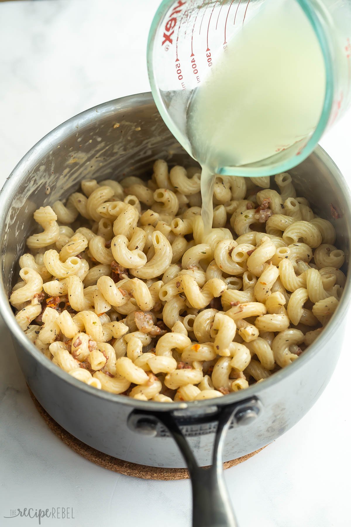 pasta water being added to cook pasta in pot.