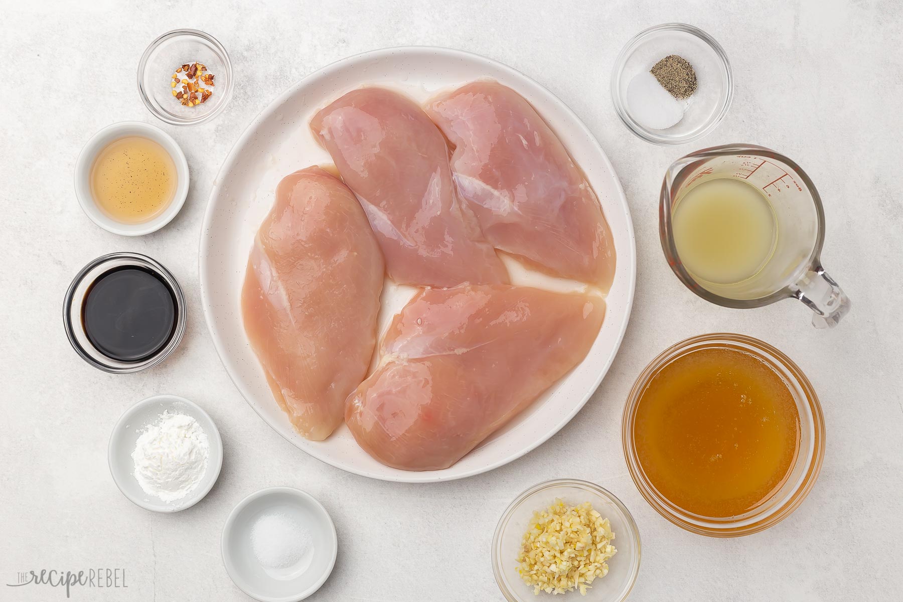 crockpot honey garlic chicken ingredients in glass bowls.