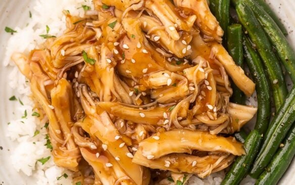 shredded honey garlic chicken on white rice and a side of green beans.