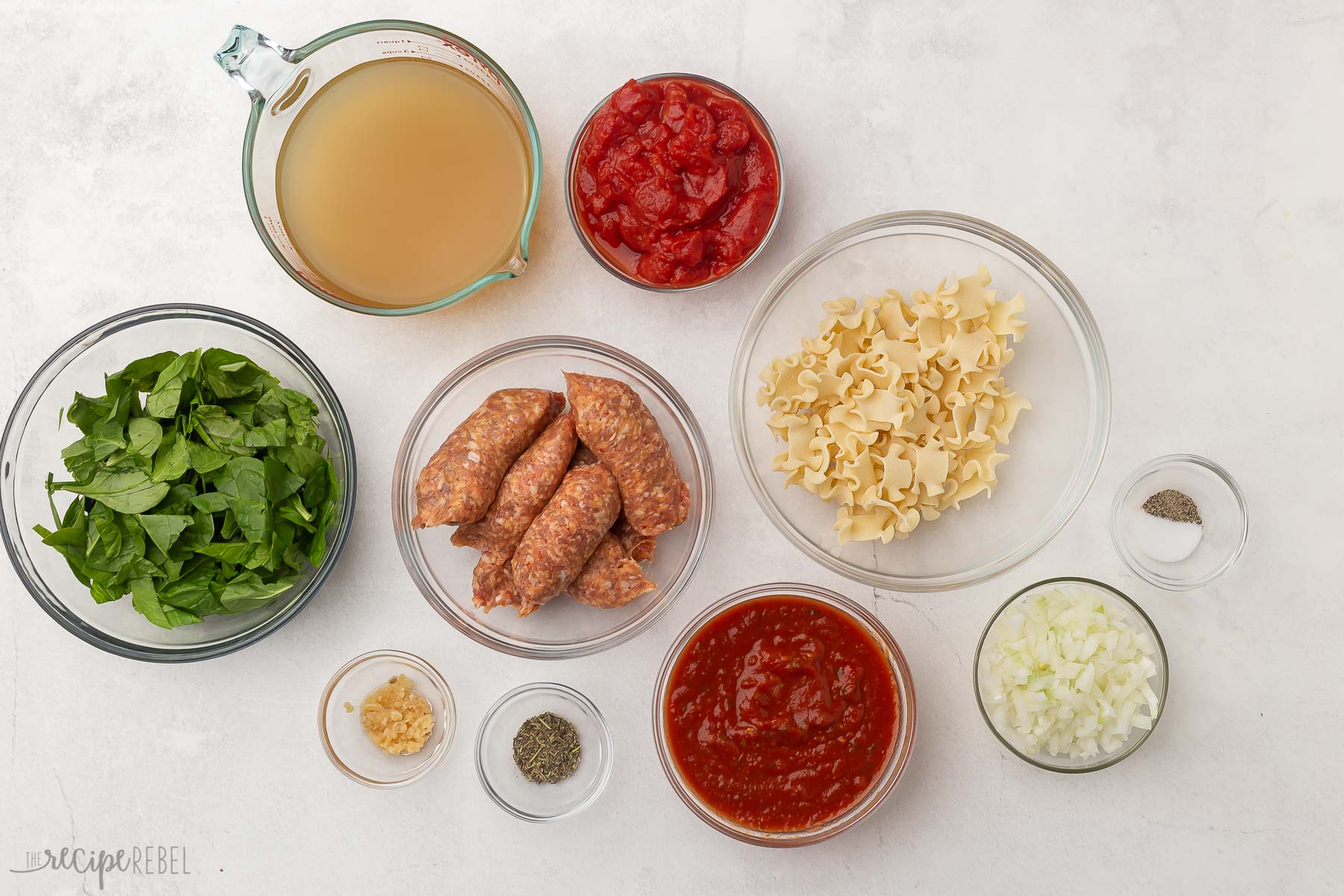 Top view of lasagna soup ingredients in glass bowls.